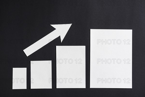 Increasing plain white graph with arrow black backdrop