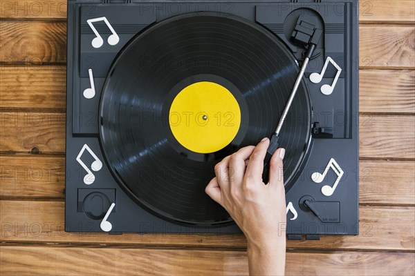 Person playing vinyl record player