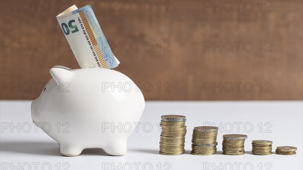 Side view piggy bank with coins banknotes