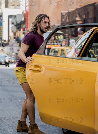 Young man riding taxi city