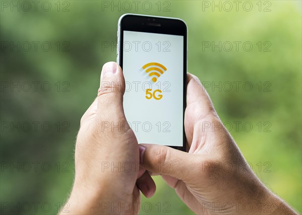 Phone with 5g screen held hands