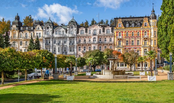 Row of houses with Art Nouveau facades by the autumnal spa park