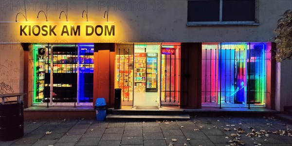 Brightly coloured illuminated kiosk at the cathedral