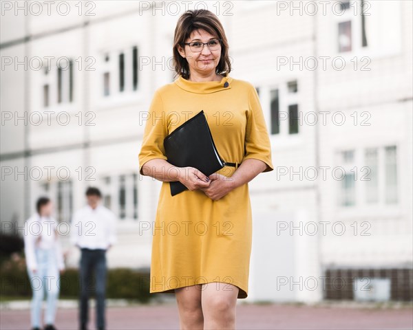 Teacher with notebook outdoor