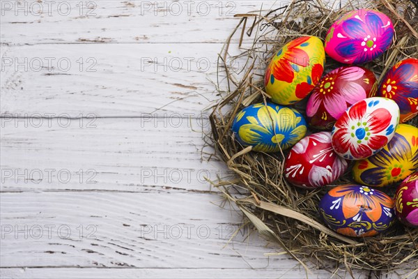 Top view wooden surface with painted easter eggs