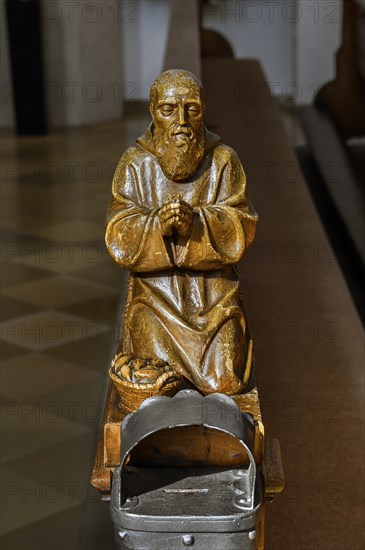 Praying figure on a church bench