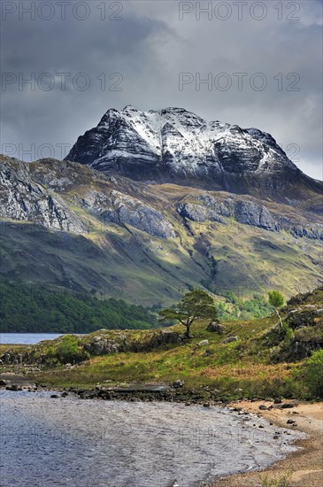 Loch Maree and the mountain Slioch covered in snow in spring