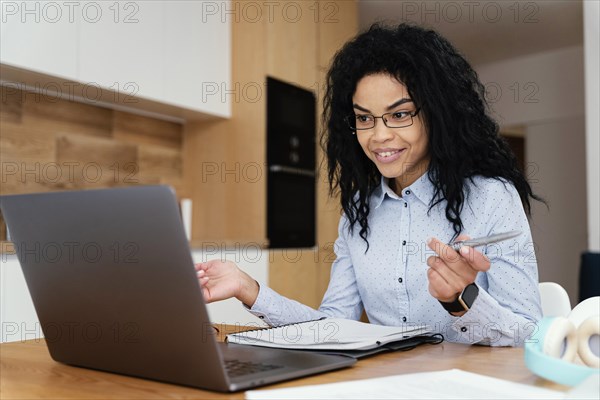 Teenage girl home during online school with laptop