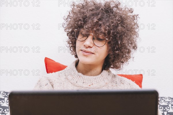 Teenager glasses using laptop