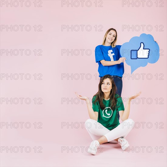 Woman with thumbs up sign speech bubble her friend shrugging