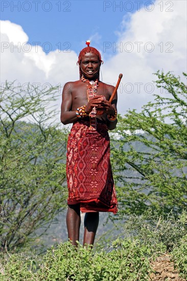 Portrait of young Turkana warrior in traditional red clothing in northwest Kenya