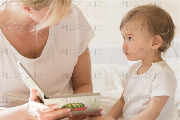 Mom reading baby bed