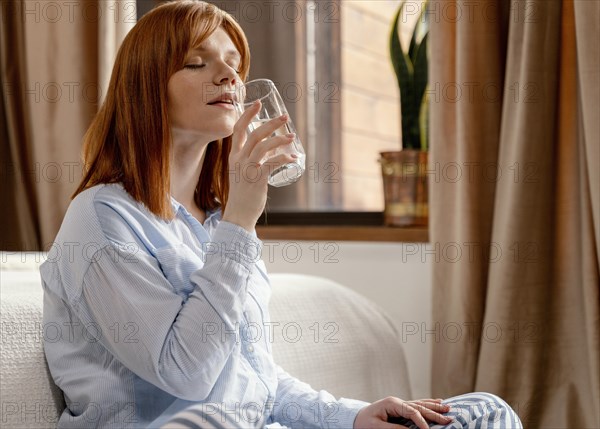 Portrait woman home drinking glass water