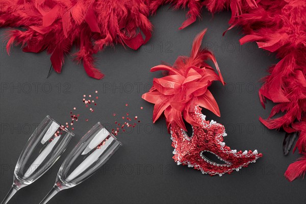 Top view carnival masks with feathers champagne glasses