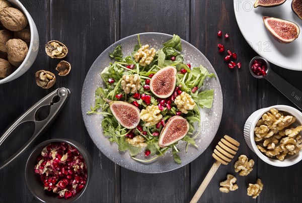 Top view plate with autumn fig salad walnuts