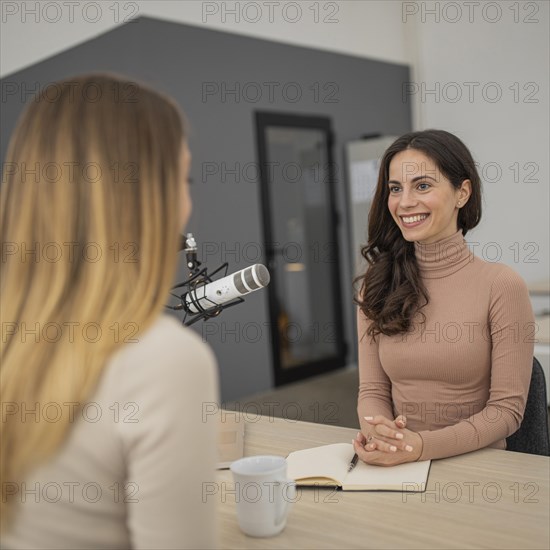 Two women broadcasting together radio