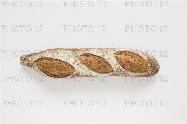 Whole rustic baked baguette white background