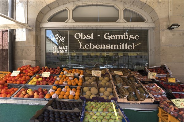 Different types of fruit in front of a fruit shop