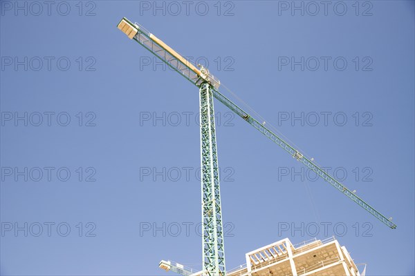 Low angle view construction site against blue sky
