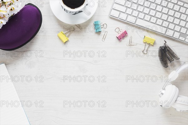 Office supplies coffee cup headphone keyboard white desk