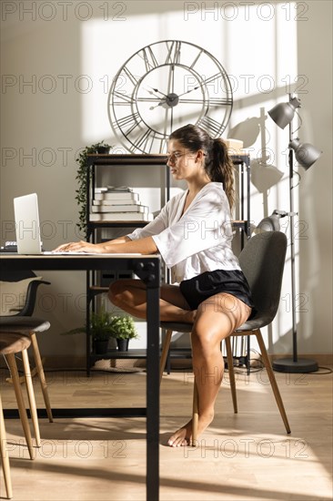 Woman sitting table working laptop