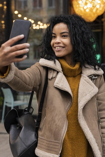 Woman taking selfie with her smartphone