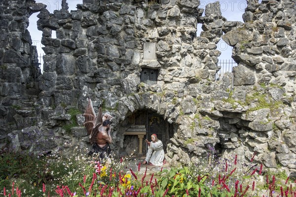 Sculpture of the devil and St Anthony of Padua at grotto in the village Crupet