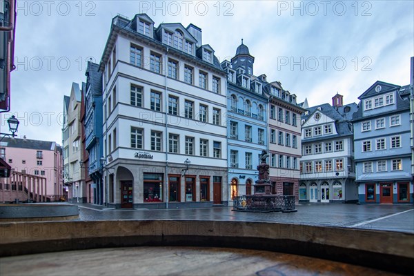 Reflection in a puddle between a historic city centre. Cityscape at the Roemer and the historic houses and streets. Cityscape in Frankfurt am Main