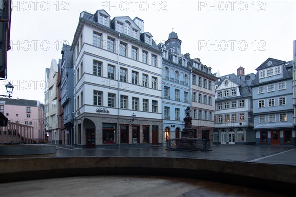 Reflection in a puddle between a historic city centre. Cityscape at the Roemer and the historic houses and streets. Cityscape in Frankfurt am Main