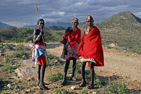 Portrait of Samburu warriors in traditional red dress with spears