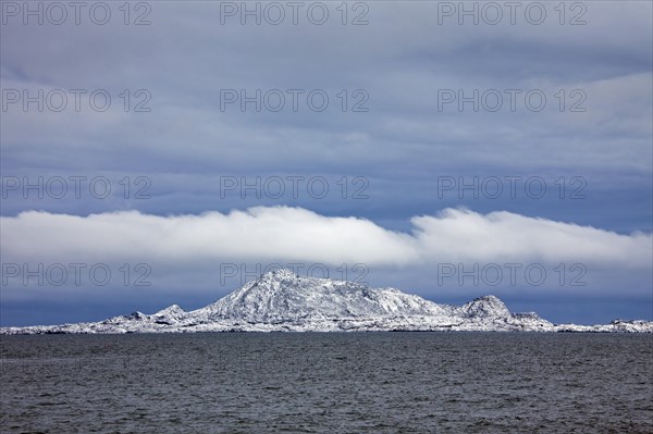 View over the Gimsoystraumen fjord and mountains in the snow in winter