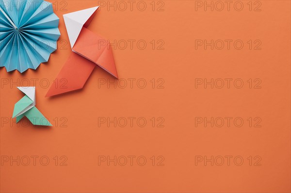 Origami paper craft art dark orange surface