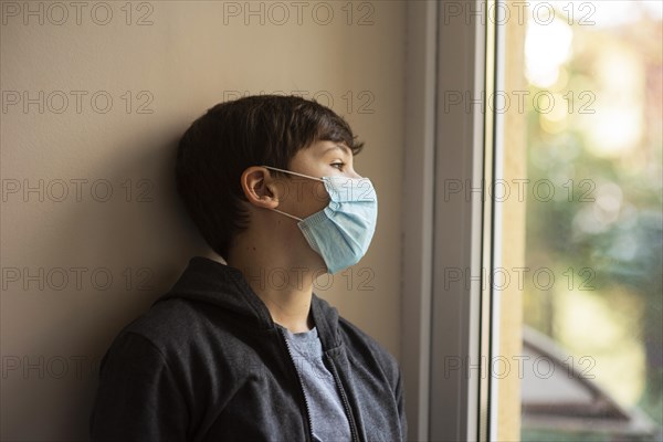 Side view little boy with medical mask looking away