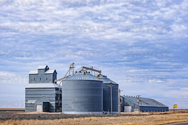 Silos connected to a grain elevator on a farm on the Great Plains in western New Mexico