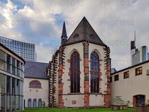 Old Carmelite monastery in front of modern skyscrapers in the banking district