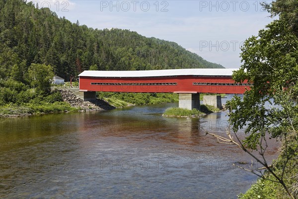 Red covered bridge over Matapedia River