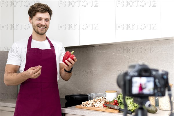 Portrait blogger recording cooking video home