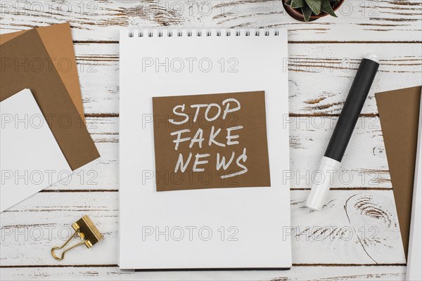 Stop fake news concept top view