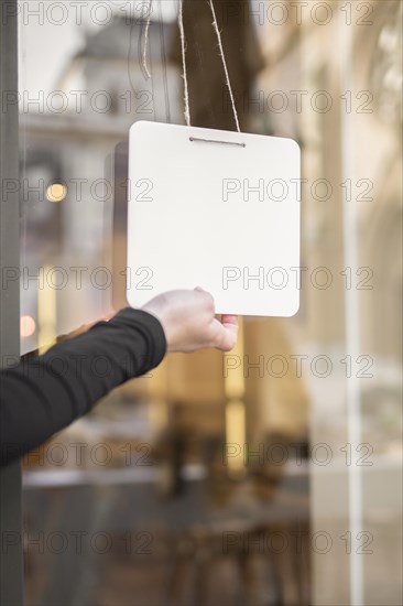 Young woman opening restaurant