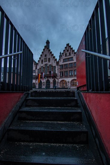 Reflection in a puddle between a historic city centre. Cityscape at the Roemer and the historic houses and streets. Cityscape in Frankfurt am Main