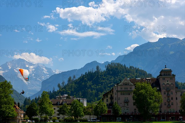 Paragliding in front Of Snow Capped Jungfraujoch Mountain in a Sunny Day in Interlaken