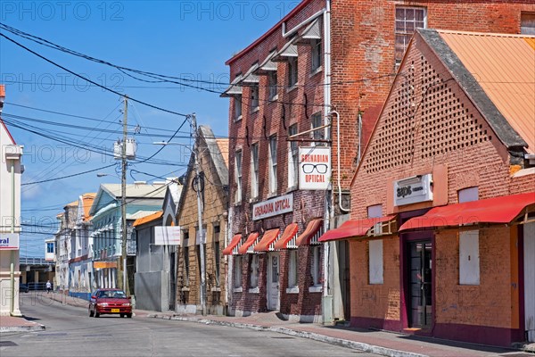 Street with red brick buildings in the British colonial centre of the capital city St. George's on the west coast of the island of Grenada