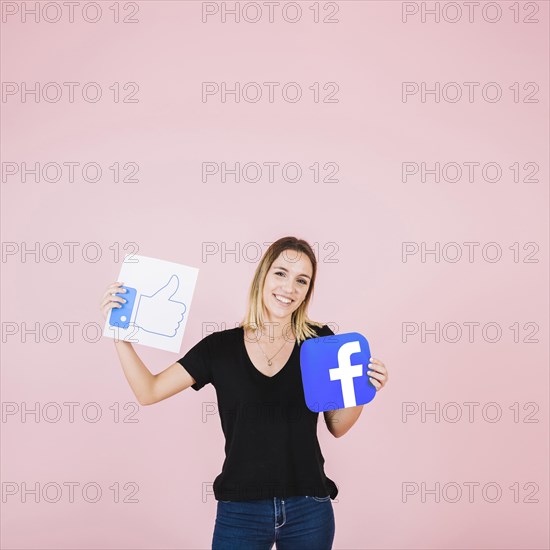 Portrait happy woman with facebook thumbs up icon