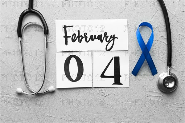 Stethoscope around colon cancer ribbon date