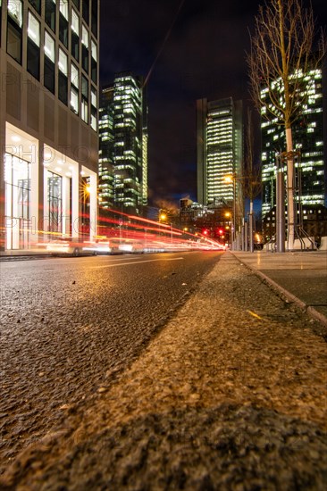 Sunset between skyscrapers. Cityscape with modern office buildings and streets. Insurance companies and banks as a cityscape in Frankfurt am Main