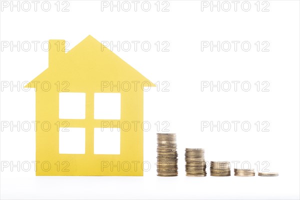 Real estate house piles coins white background