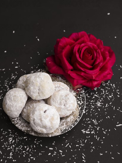 Top view islamic pastries with red rose