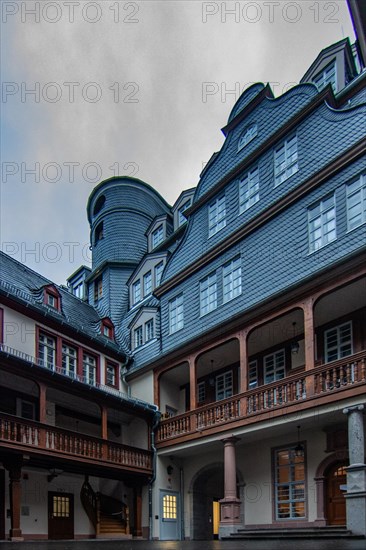 Reflection in a puddle between a historic city centre. Cityscape at the Roemer and the historic houses and streets. Cityscape in Frankfurt am Main