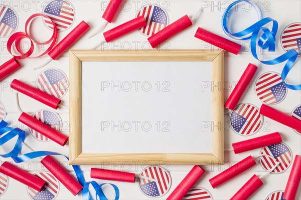Red firecrackers ribbon usa flag badges around blank wooden white board