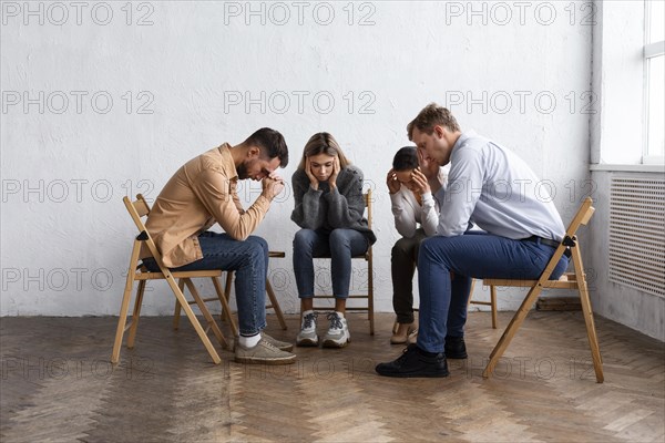 Sad people chairs group therapy session